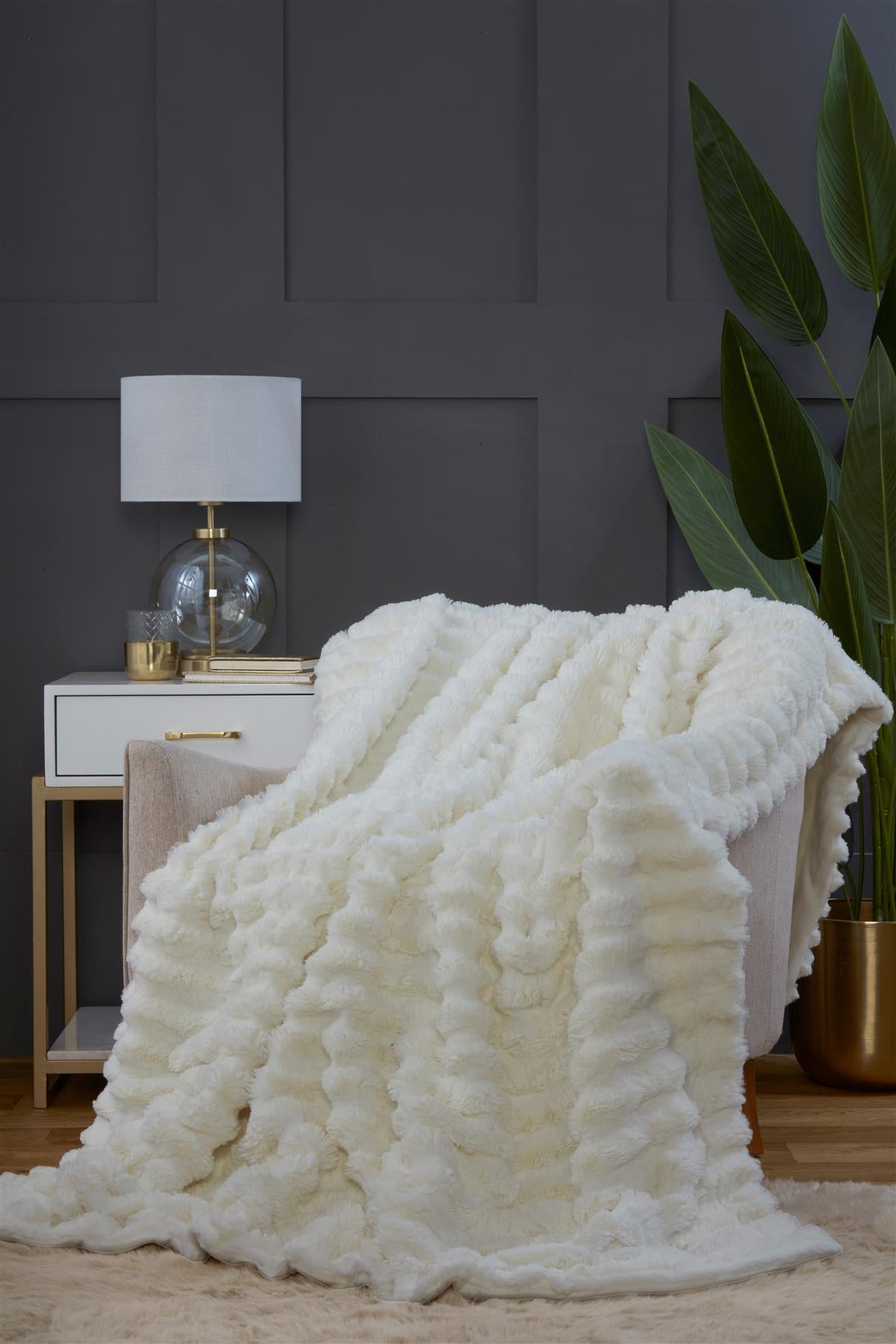 Rabbit fur throw styled on a bed to add a touch of sophistication and comfort