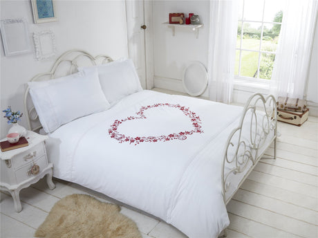Matching pillowcases with embroidered hearts, pintucks, and detailed motifs for a cohesive bedroom look