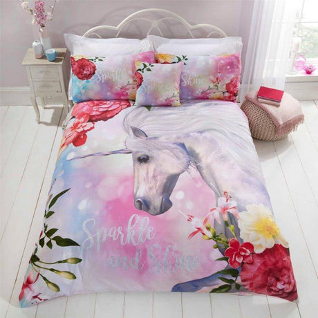 A vibrant duvet set featuring a printed unicorn surrounded by flowers, soft pastel colours, glitter sparkle writing, and matching pillowcases