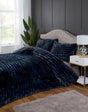 The duvet set displayed with decorative pillows, illustrating its opulent and refined aesthetic