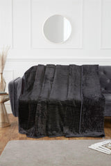 Vibrant coloured mink blanket styled on a contemporary sofa for an inviting atmosphere