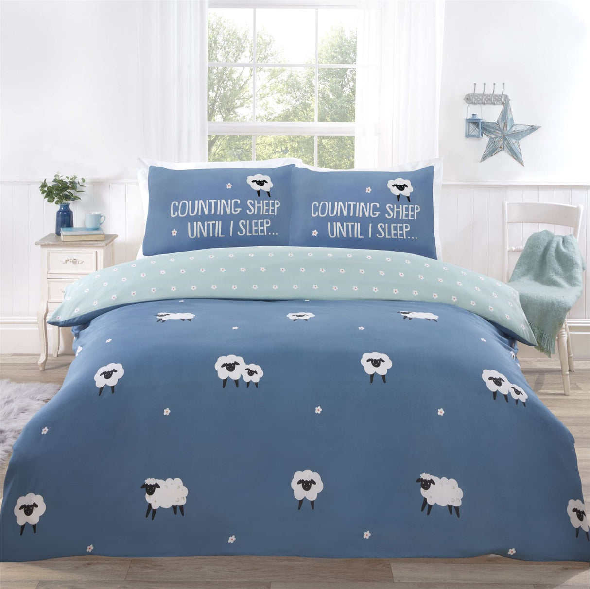 Reversible bedding with a charming ditsy daisy reverse, showcasing the Counting Sheep pattern and playful slogan on pillows