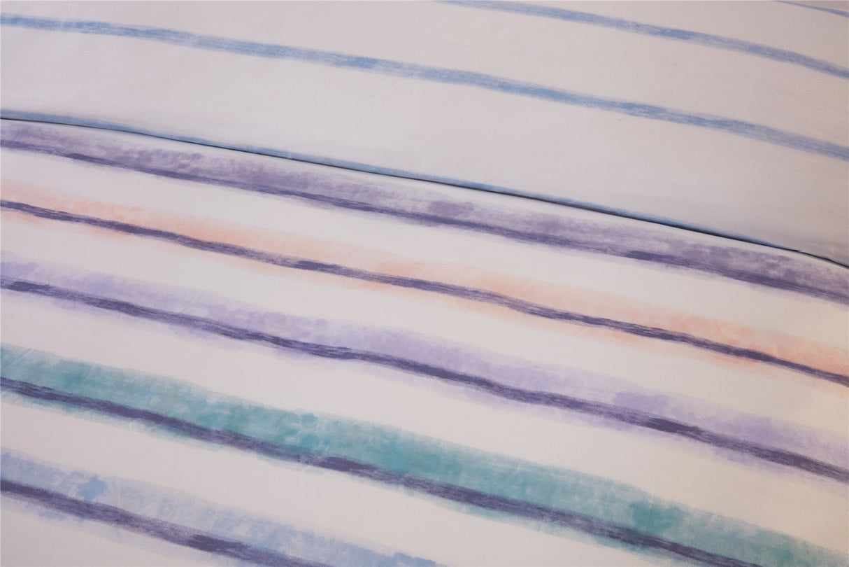 Reversible Horizon Duvet Cover Set displaying bold colourful stripes on one side and delicate blue lines on a white background on the reverse