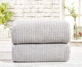 A soft and absorbent waffle towel in a neutral color