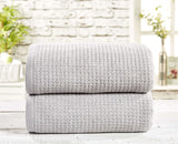 A soft and absorbent waffle towel in a neutral color