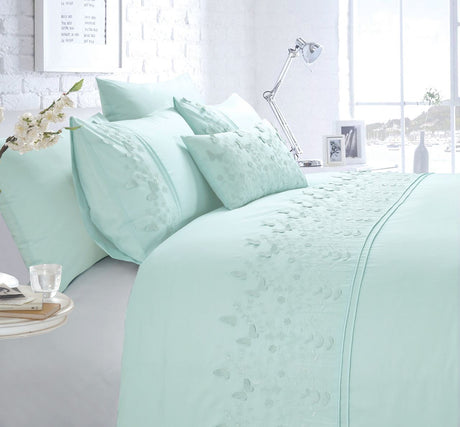 A charming Papillon Boudoir Cushion in duck egg colour showcasing detailed embroidery and butterfly embellishments for an elegant look