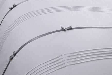 Chic Clarissa duvet set highlighting sophisticated pintuck details and decorative bow accents