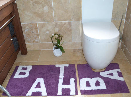 Luxurious natural cotton bath mat featuring the word bath in elegant lettering alongside a matching pedestal mat