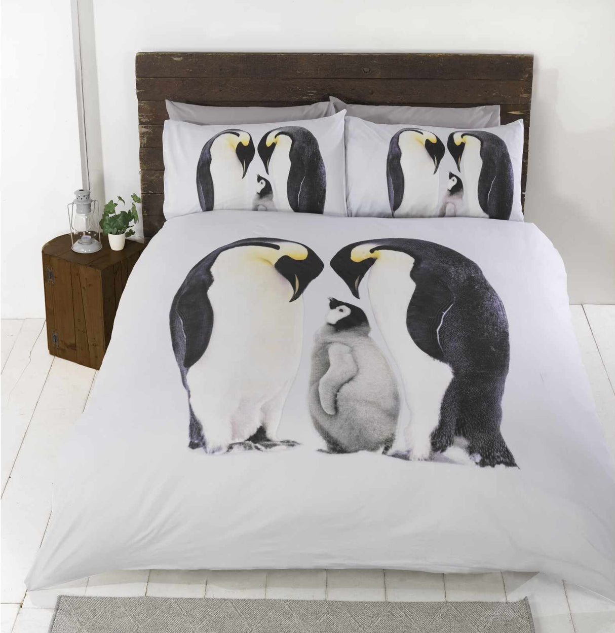 A charming photographic print on the Penguin Duvet Set showcasing an adorable family of penguins, highlighting their cute and friendly appearance for a cosy and inviting bedroom decoration