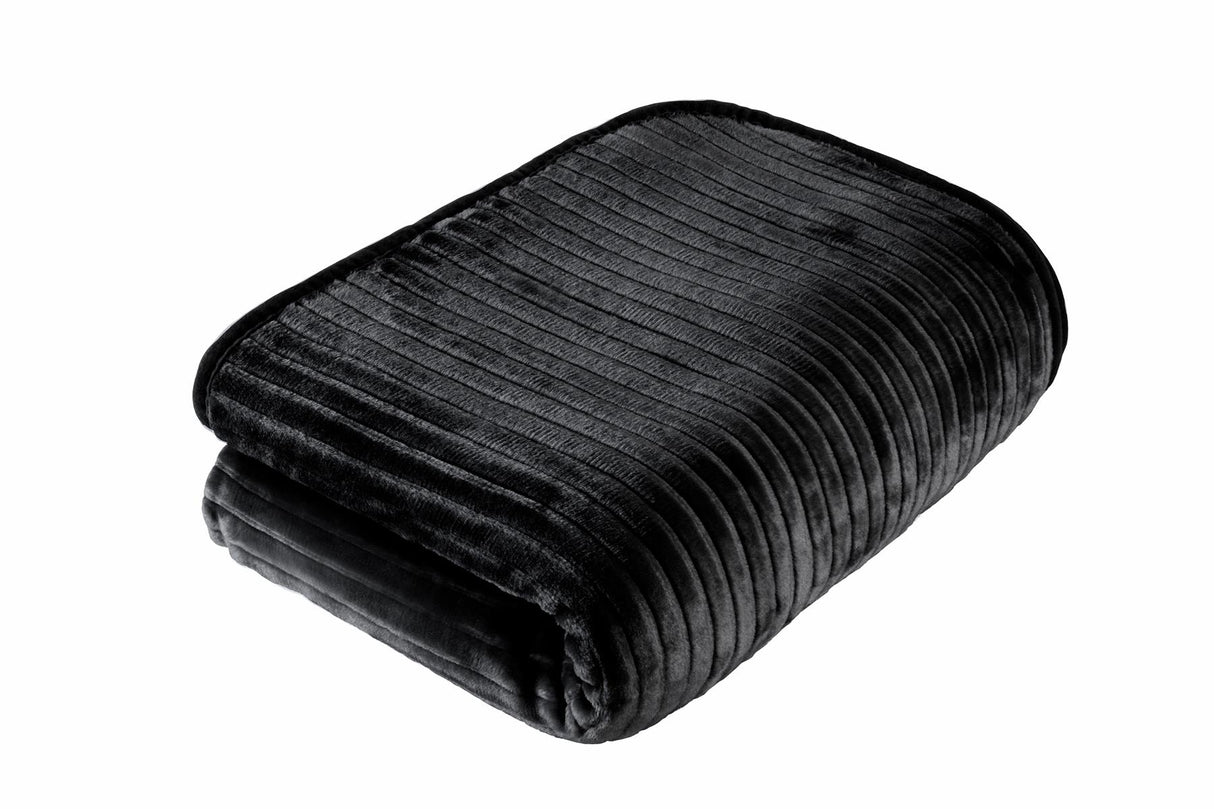 Vivid colours and textured ribbing showcased on a plush mink blanket in a stylish lounge