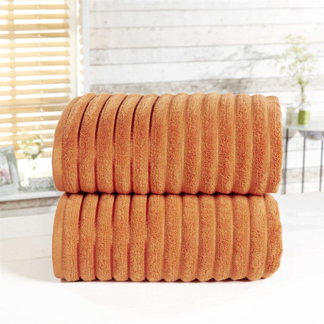 Elegant bath sheet with ribbed texture, stripe weave, and silky sheen border, ideal for wrapping or drying