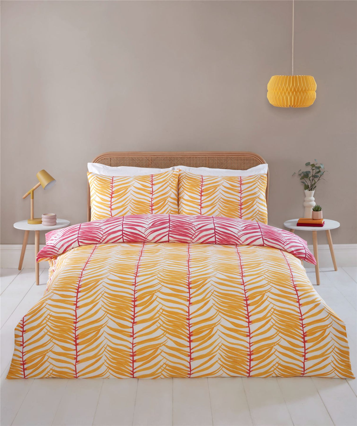 Vibrant tropical duvet cover featuring bold palm leaf patterns in sunny yellow and pink on a white background