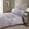 Close-up of Aurora Duvet Set showcasing intricate floral embroidery and button closure