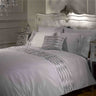 Elegant bedroom display showcasing the Crystal Duvet Set with its shimmering silver faux silk surface and luxurious diamanté embellishments