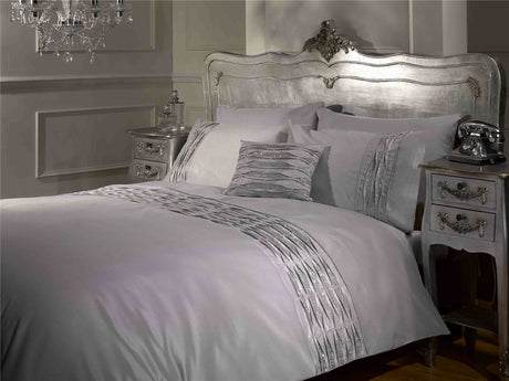 Elegant bedroom display showcasing the Crystal Duvet Set with its shimmering silver faux silk surface and luxurious diamanté embellishments
