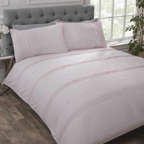 Luxurious Clarissa duvet set featuring pintuck detailing and contrasting ribbon bows