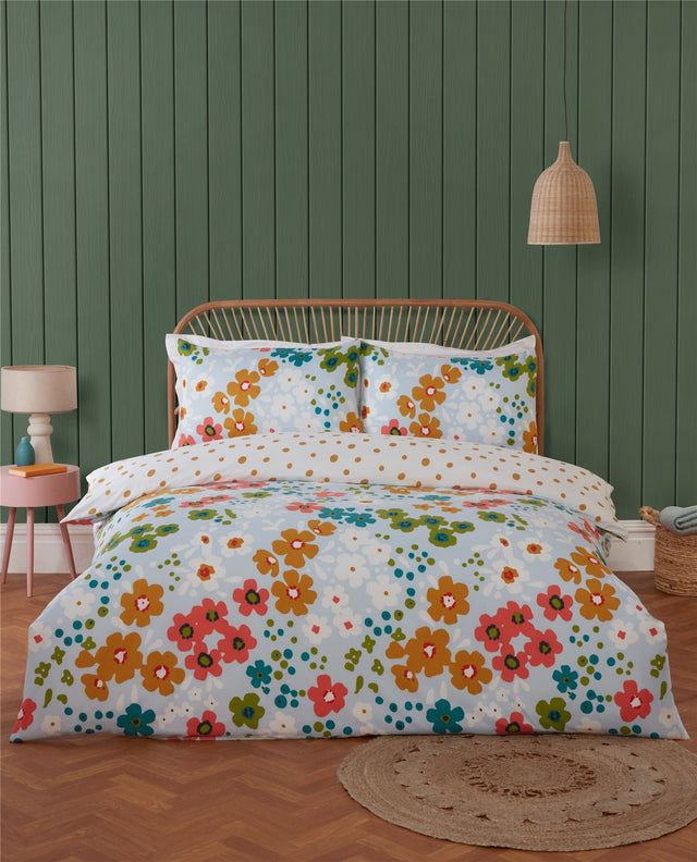 Bright, colourful Betty Duvet Set featuring a scattered floral pattern with warm oranges, soft pinks, and cool blues and greens across a whimsical garden-inspired bedding design