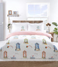 Brightly coloured Padstow Duvet Set featuring beach huts and seagulls in a watercolour style, fully reversible with a seaside stripe pattern on white microfibre fabric