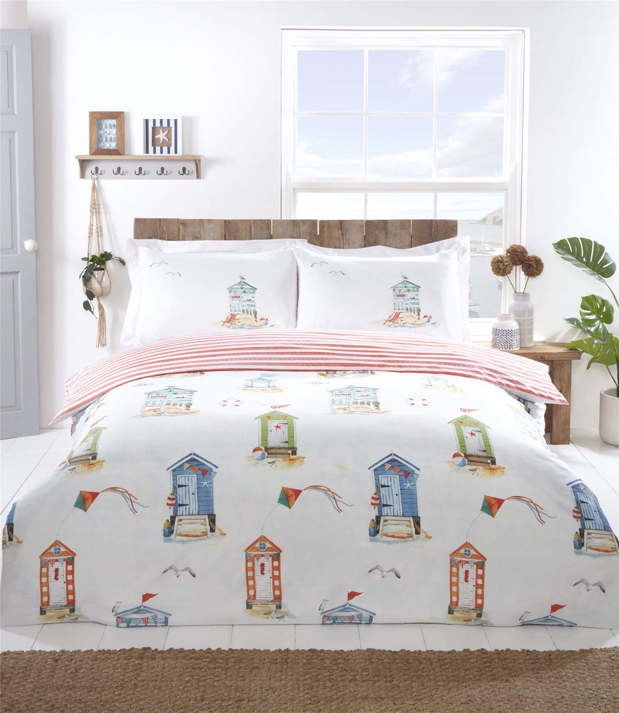 Brightly coloured Padstow Duvet Set featuring beach huts and seagulls in a watercolour style, fully reversible with a seaside stripe pattern on white microfibre fabric