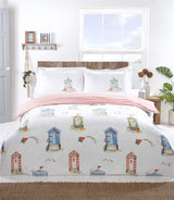Brightly coloured Padstow Duvet Set featuring beach huts and seagulls in a watercolour style, fully reversible with a seaside stripe pattern on white microfibre fabric
