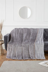 The plush ribbed mink throw casually thrown over a contemporary armchair for comfort