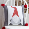 A festive Gonk Filled Cushion featuring two different gonk designs in simple winter colours, embellished with chunky pompoms at each corner, adding a fun and quirky Scandinavian-inspired touch to seasonal decor