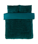 The duvet set styled with throw cushions, highlighting its versatility and sumptuous texture