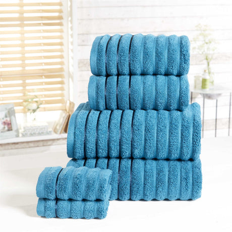 Luxury pure cotton ribbed towels featuring stripe weave and silky sheen borders for a sophisticated bathroom aesthetic