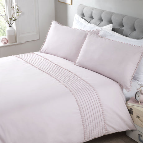 Pillowcases with matching grey pom pom trim and bobble detailing complementing the minimalistic duvet cover