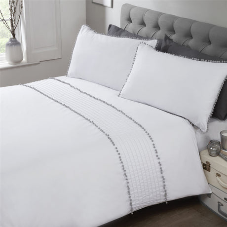 Full view of the Pom Poms Duvet Set displaying the elegant grey bobble trim on both duvet cover and matching pillows