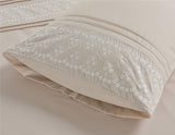 Close-up of delicate floral embroidery and graceful pleats on the Charlotte Duvet Set’s soft fabric