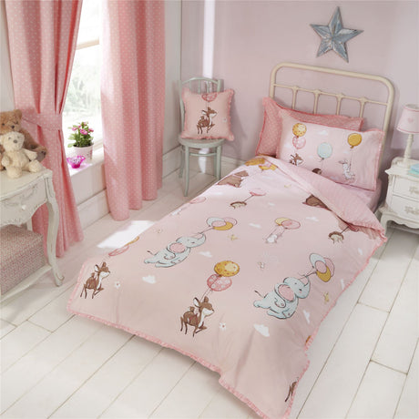 A charming kids’ duvet cover set featuring adorable animals floating with balloons on the front, with a pretty polka dot pattern on the reverse and a delicate frilly trim detail