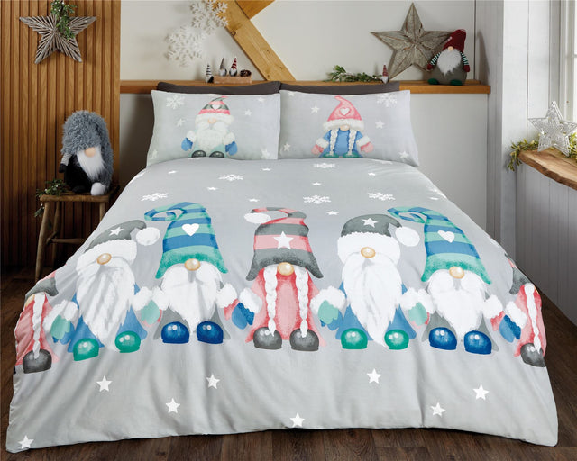 A whimsical Gonk Family duvet set featuring adorable gonks with oversized hats, gloves, and boots on a grey background with twinkling stars and icicles, made from soft microfibre fabric with a fully reversible design, perfect for winter-themed bedrooms