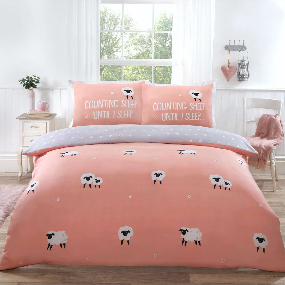 Cozy duvet set featuring a playful Counting Sheep design in blush pink with fluffy sheep and slogan