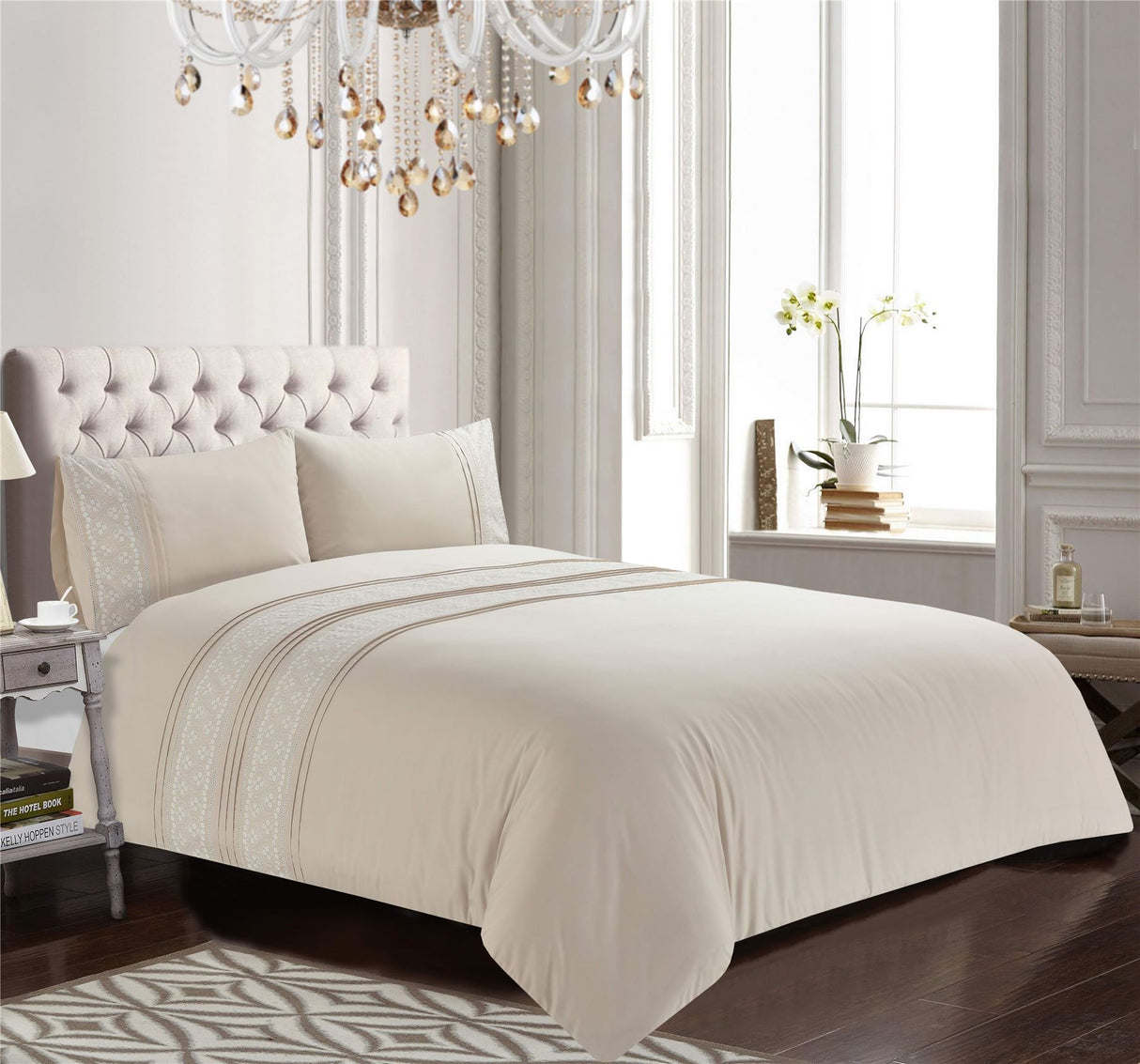 Intricately embroidered floral details and pleated accents on a neutral background of the Charlotte Duvet Set