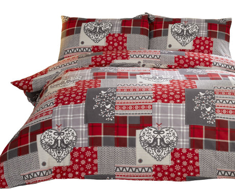 Close-up of the traditional alpine patchwork duvet cover with charming motifs and button closure in red and grey shades