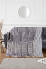 Vividly coloured ribbed mink blanket adding warmth and a touch of elegance to a contemporary living room