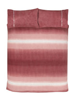 Cozy bedroom setting featuring the Teddy fleece duvet set with plush textures and ombre stripes