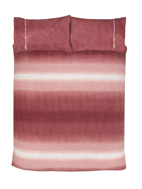Cozy bedroom setting featuring the Teddy fleece duvet set with plush textures and ombre stripes