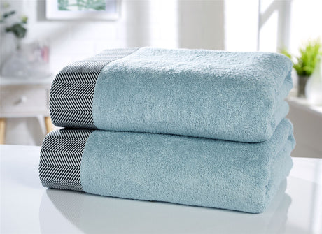 Soft and absorbent bath towel featuring textured herringbone edging for stylish bathroom decor