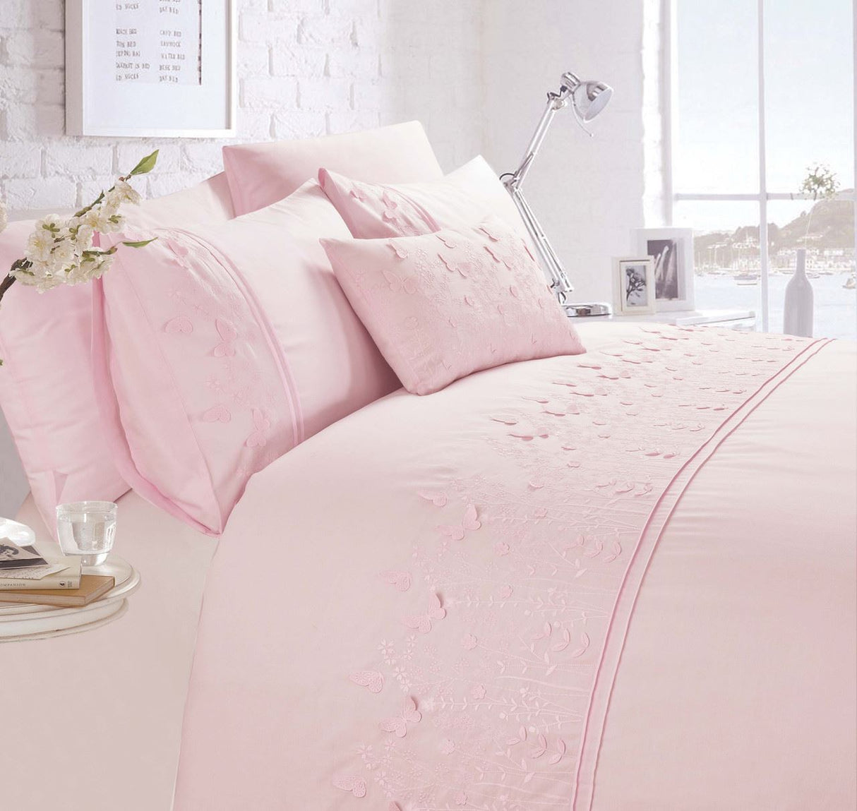 A beautifully embroidered Papillon Boudoir Cushion featuring intricate butterfly detailing in white fabric