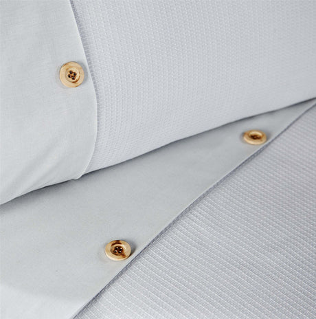 Elegant waffle-design duvet cover featuring stripe patterns and a subtle horizontal border with button accents