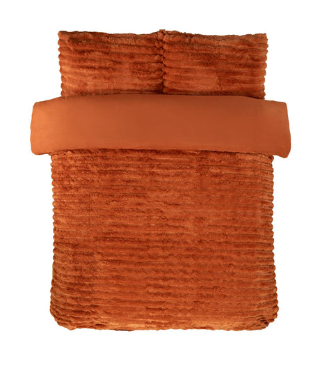 Soft lighting illuminating the rich colour and velvety texture of the faux-fur bedding collection