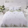 Bright tropical leaf design on the front of the sustainably sourced cotton and recycled polyester duvet cover