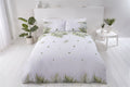 Bright tropical leaf design on the front of the sustainably sourced cotton and recycled polyester duvet cover