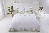 Bright tropical leaf design on the front of the sustainably sourced cotton and recycled polyester duvet cover