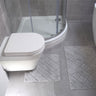 Luxury bathroom accessory set including a large bath mat with diamond pattern and a compact pedestal mat