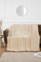 Cozy corner with a sofa draped in the luxurious ribbed mink blanket for warmth