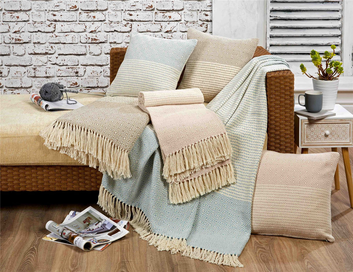 Detailed view of Rona Throw’s tassels and intricate striped and geometric pattern in cream with natural accents