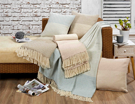Detailed view of Rona Throw’s tassels and intricate striped and geometric pattern in cream with natural accents